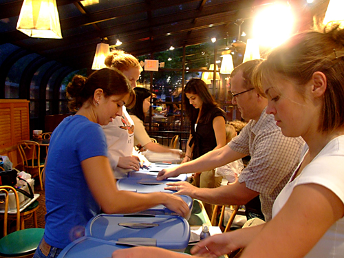 medical school students prepare materials to teach students about skin cancer prevention